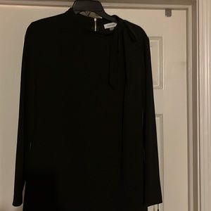 Black dress, with cute tie in the front and beautiful gold zipper in the back.